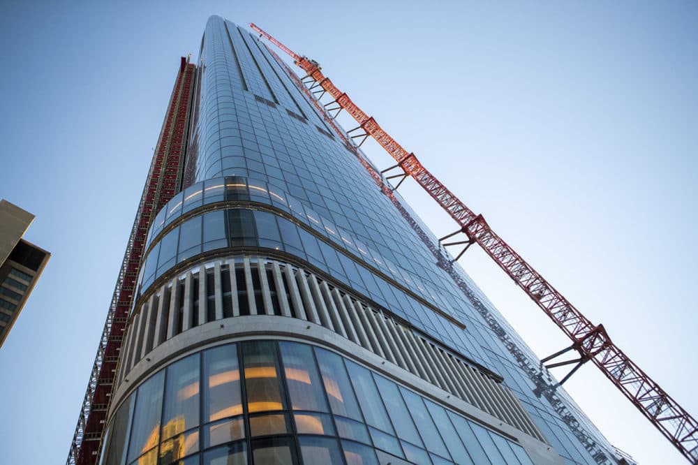 The crane's mast extends all the way up the side of One Dalton. (Jesse Costa/WBUR)