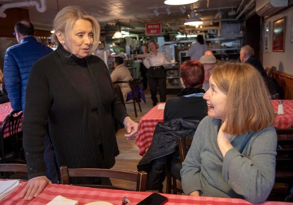 Head waitress Gina Schertzer chats with former waitress Joyce Monac. (Robin Lubbock/WBUR)