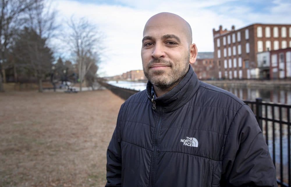 José Bou, who's the equity family and community partnerships manager with Holyoke Public Schools, stands by a canal in the western Massachusetts city. (Robin Lubbock/WBUR)