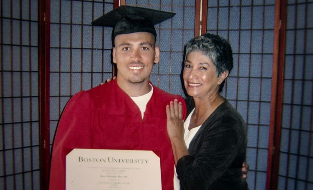 José Bou, with his degree from Boston University, stands with Joann Mizell, who Bou says has been a mother figure in his life. (Robin Lubbock/WBUR)