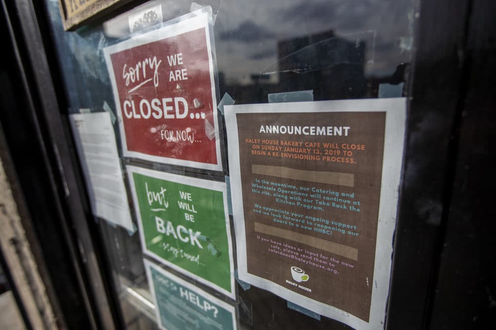 A sign on the front door of the Haley House in Dudley Square in Roxbury explains it closed its retail operation during a re-envisioning process. Meanwhile, the non-profit's catering and wholesale operations will continue. (Jesse Costa/WBUR)