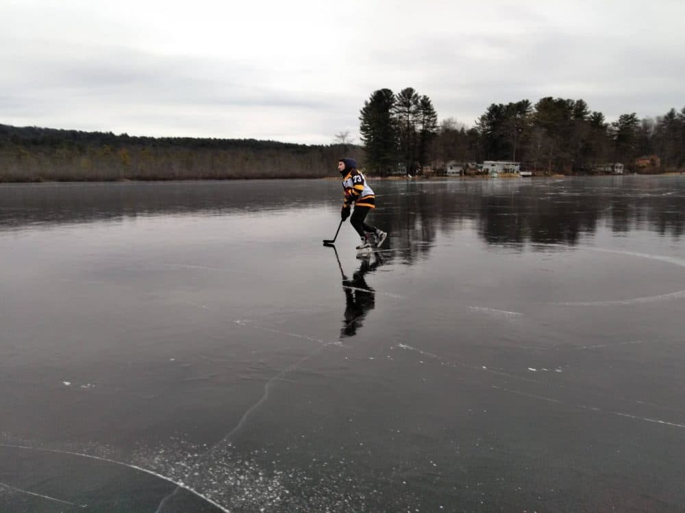 Raymond Langevin glides on the black ice on Metacomet Lake in Belchertown. (Jill Kaufman/NEPR)