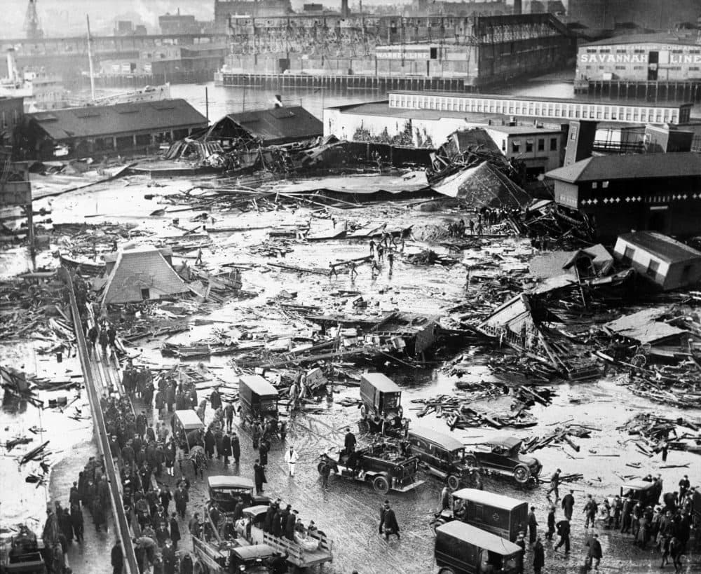 The ruins of a tank containing 2 1/2 million gallons of molasses lie in a heap after an eruption that hurled trucks against buildings and crumpled houses in the North End of Boston, on Jan. 15, 1919. The disaster took 21 lives and injured 40. (AP)