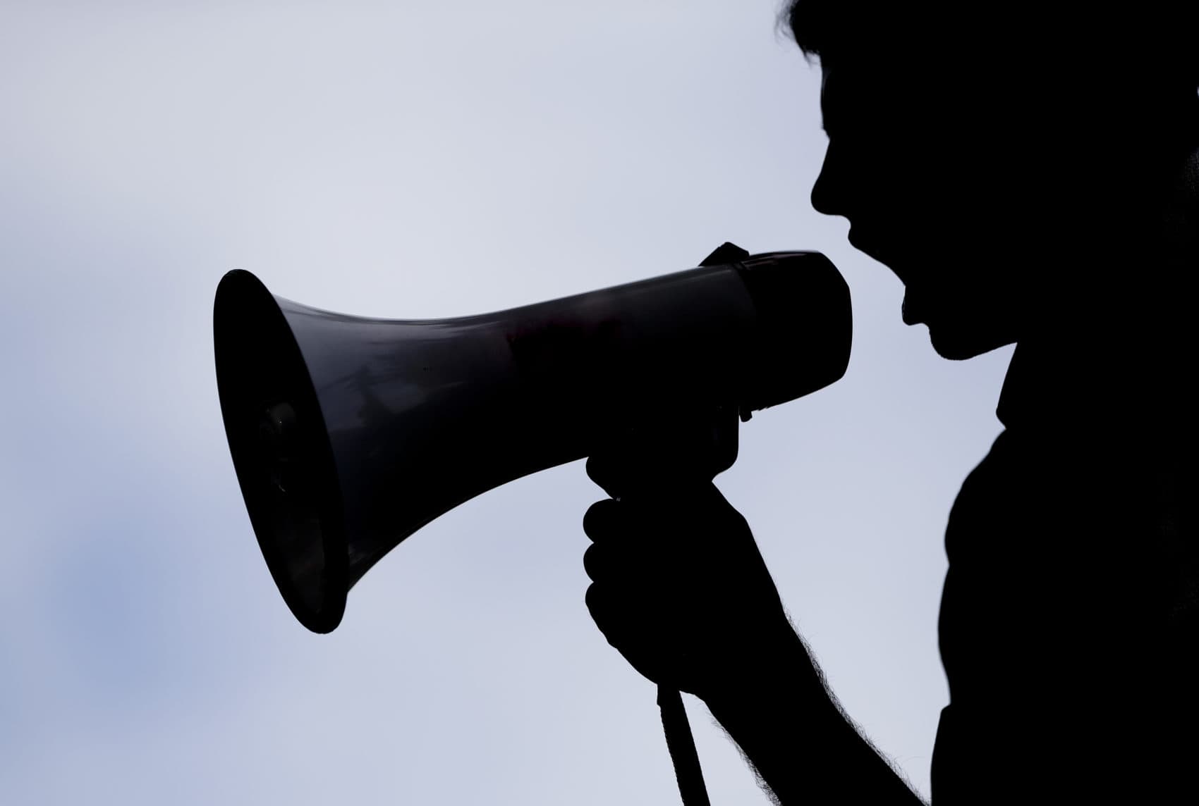 A supporter of Sen. Bernie Sanders, I-Vt., yells at delegates through a bullhorn at Franklin Delano Roosevelt Park in Philadelphia, Tuesday, July 26, 2016, during the second day of the Democratic National Convention. (Matt Slocum/AP)