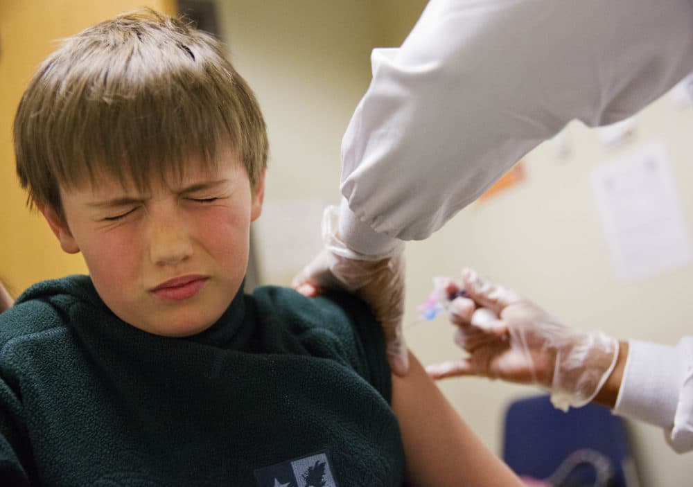 An 8-year-old boy gets a flu shot at a Dekalb County health center in Decatur, Ga., Monday, Feb. 5, 2018. (David Goldman/AP)