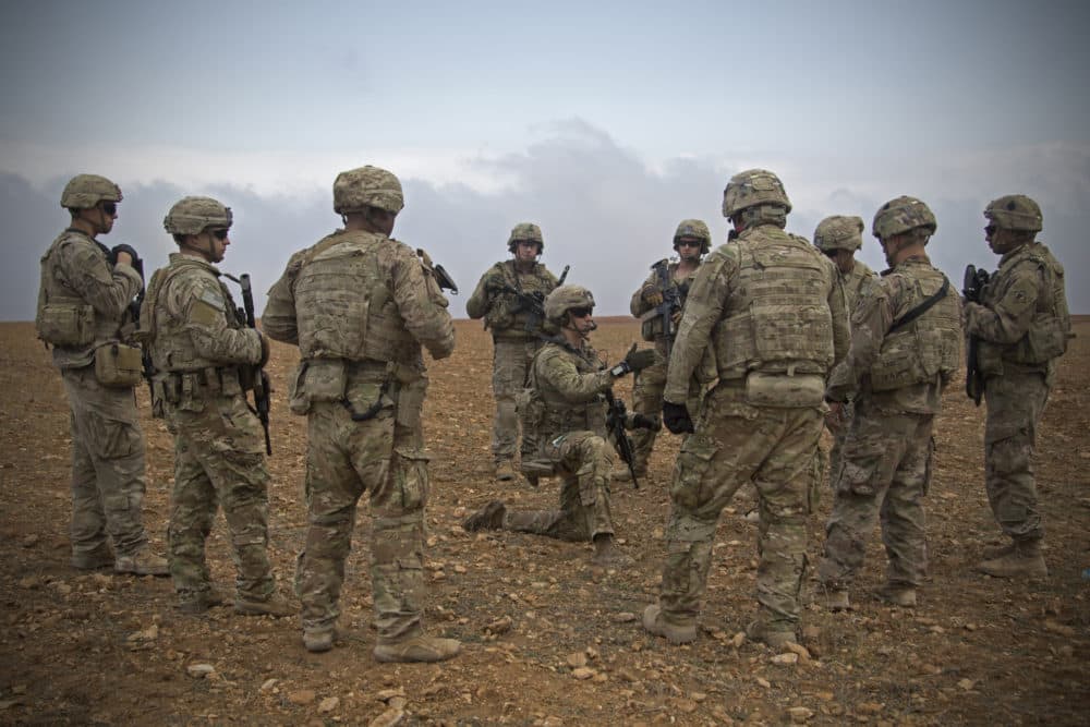 In this Nov. 7, 2018, photo released by the U.S. Army, U.S. soldiers gather for a brief during a combined joint patrol rehearsal in Manbij, Syria. (U.S. Army photo by Spc. Zoe Garbarino via AP)