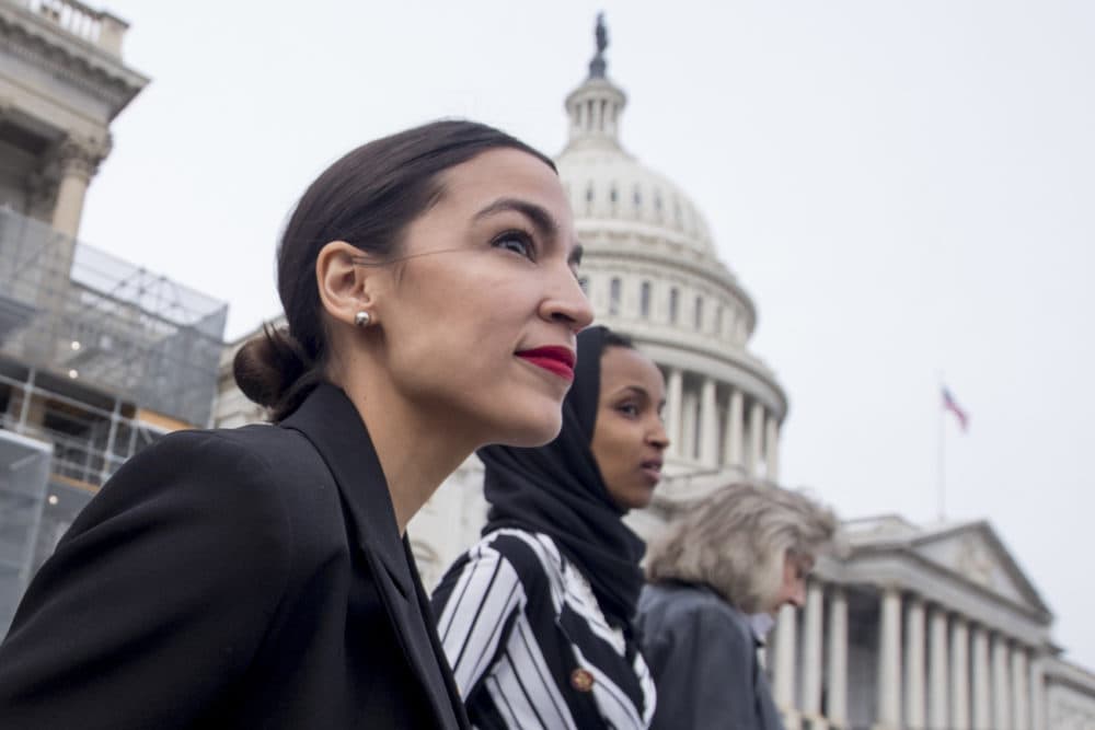 Rep. Alexandria Ocasio-Cortez, left, and D-N.Y., Rep. Ilhan Omar, D-Minn., center, walk down the House steps to take a group photograph of the House Democratic women members of the 116th Congress on the East Front Capitol Plaza on Capitol Hill in Washington, Friday, Jan. 4, 2019, as the 116th Congress begins. Also pictured is Rep. Dina Titus, D-Nev., right. (Andrew Harnik/AP)
