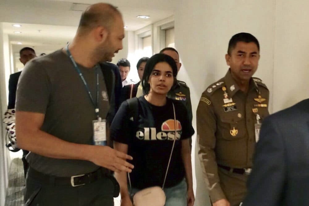 In this Jan. 7, 2019, file photo released by the Immigration Police, Chief of Immigration Police Maj. Gen. Surachate Hakparn, right, walks with Saudi woman Rahaf Mohammed Alqunun before leaving the Suvarnabhumi Airport in Bangkok, Thailand. (Immigration police via AP, File)