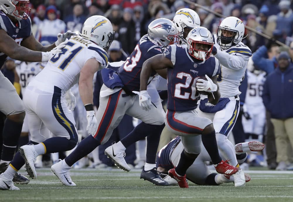 Patriots running back Sony Michel (26) runs from Chargers outside linebacker Kyle Emanuel (51) during the second half. (Elise Amendola/AP)