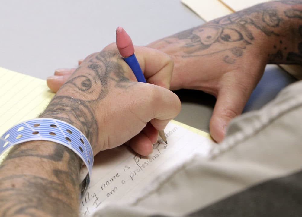 In this March 25, 2014 photo, an inmate works on an essay for a GED class at the 192-bed facility at the Stanislaus County Jail in Modesto, Calif. (Rich Pedroncelli/AP)