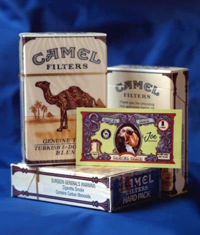 Packs of Camel cigarettes and a "Camel cash" coupon are displayed in 1997. Joe Camel, the jazzy cartoon character blamed for luring kids into smoking, was retired the same year. (Richard Drew/AP)
