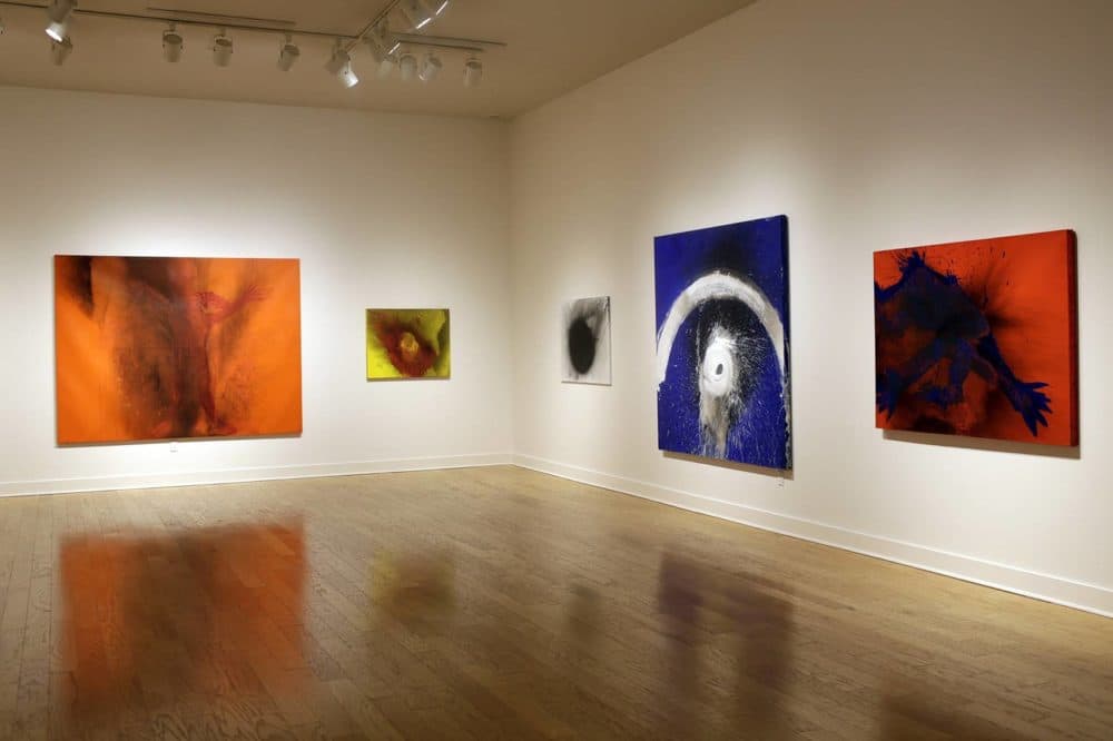 Otto Piene's oil and fire on canvas paintings hang at the Fitchburg Art Museum for an exhibition on the German-born artist who made much of his work in Groton. (Hadley Green for WBUR)