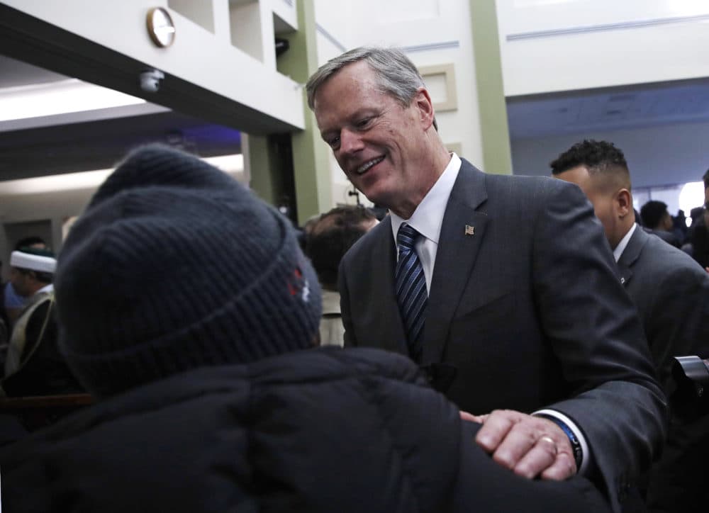 Massachusetts Gov. Charlie Baker, right, is greeted following prayer service at the Islamic Society of Boston Cultural Center's mosque in Boston on Friday. (Charles Krupa/AP)