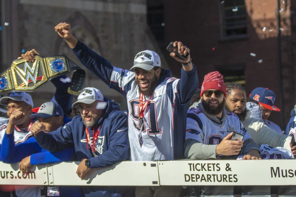 Deatrich Wise Jr. (91) raises his arms to celebrate with the crowd in Copley Square. (Jesse Costa/WBUR)