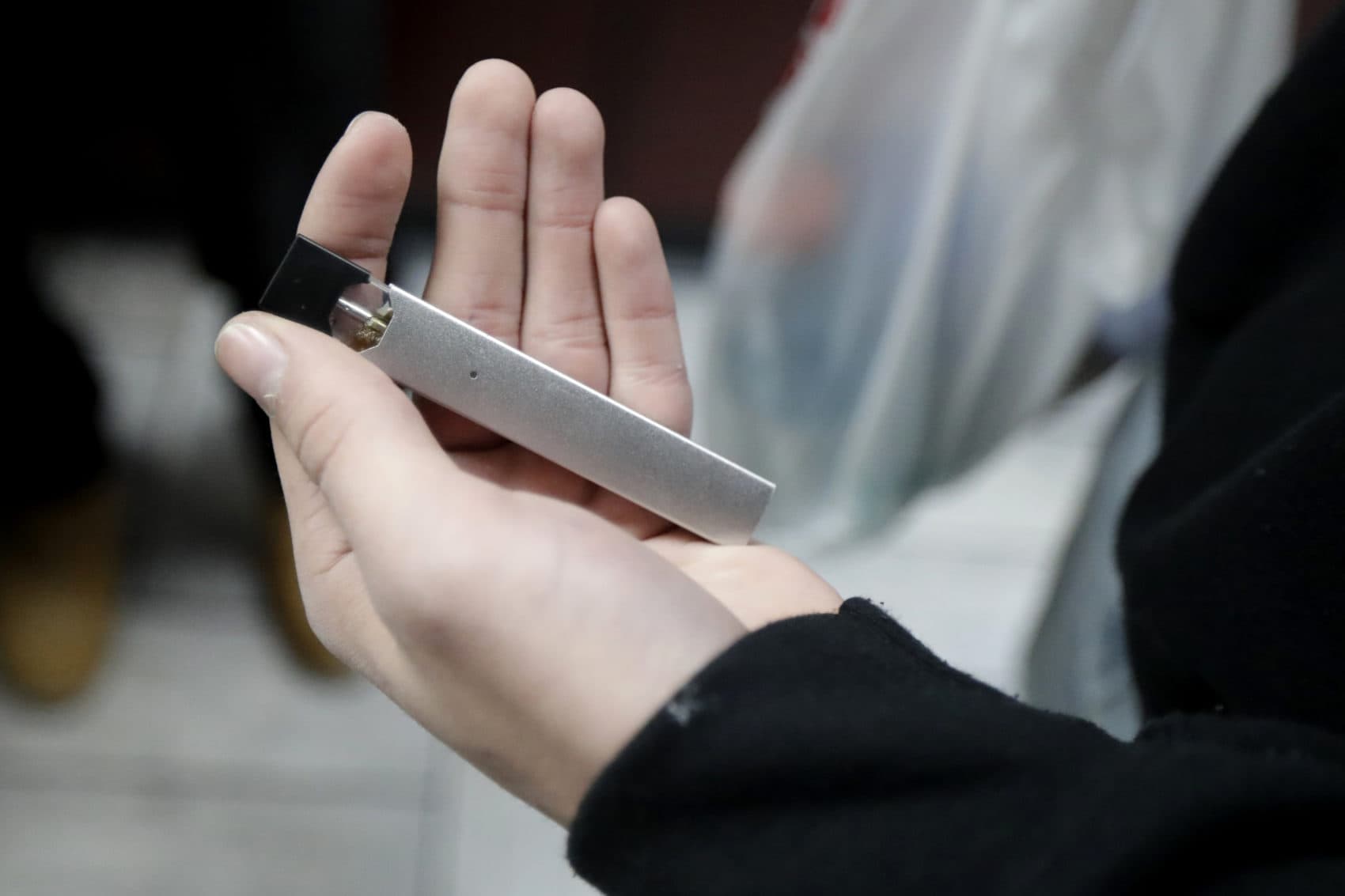In this Dec. 20, 2018, file photo, a man displays his Juul electronic cigarette. (Julio Cortez/AP)