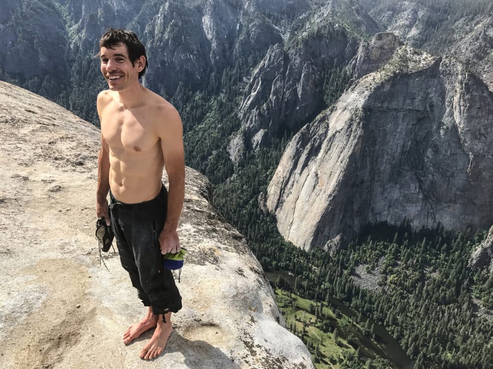 Alex Honnold holds all of his climbing gear atop the summit of El Capitan. He just became the first person to climb El Capitan without a rope. (Jimmy Chin/Courtesy of National Geographic)