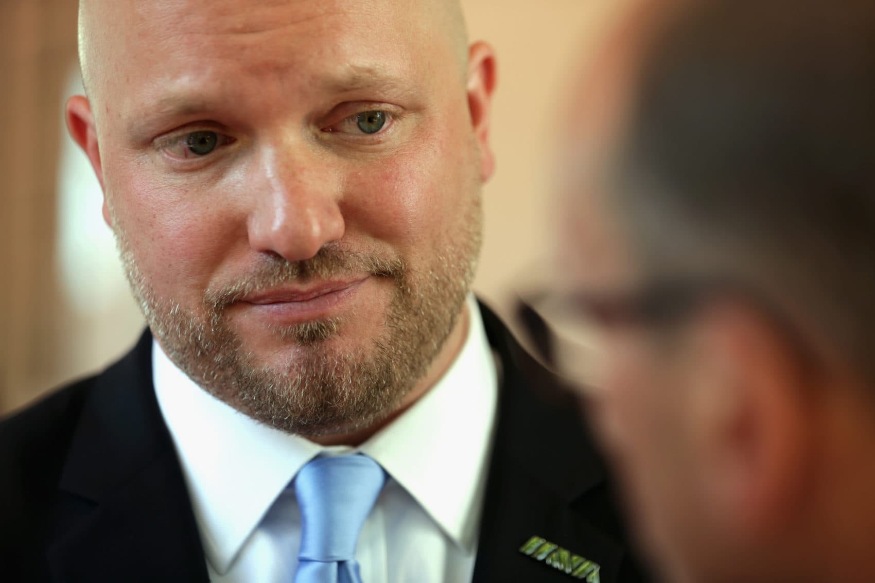 Flanked by veterans, founder and CEO of Iraq and Afghanistan Veterans of America Paul Rieckhoff speaks to a reporter after a news conference on June 2, 2014 in Washington, D.C. (Alex Wong/Getty Images)