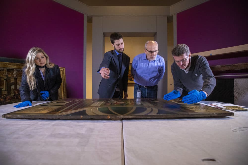 Head Registrar for Collection and Exhibitions at the Isabella Stewart Gardner Museum Amanda Prugh Venezia, William and Lia Poorvu Curator of the Collection Nathaniel Silver, Chief Conservator Gianfranco Pocobene and Accademia Carrara Museum curator Giovanni Valagussa analyze the Botticelli paintings. (Jesse Costa/WBUR)