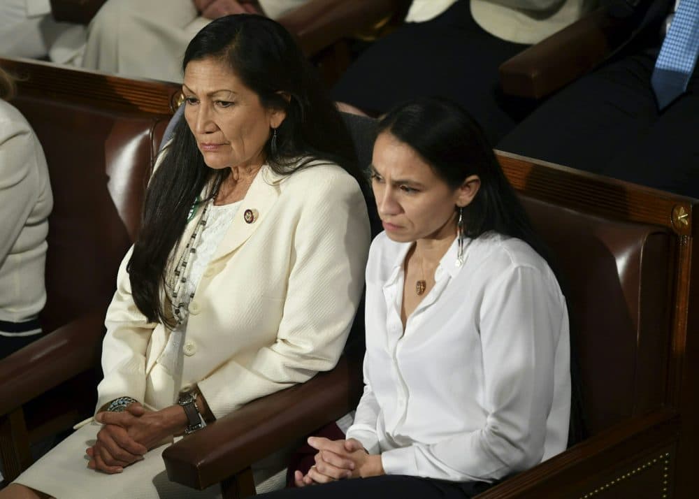 Reps. Deb Haaland (D-N.M., left) and Sharice Davids (D-Kan.) watch during President Trump's State of the Union address at the U.S. Capitol in Washington, D.C., on Feb. 5, 2019. (Mandel Ngan/AFP/Getty Images)