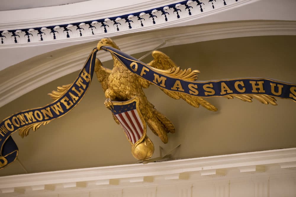 The banner reading, ”God Save the Commonwealth of Massachusetts” in the eagle’s mouth, was removed and refurbished. However, the eagle posed too many problems to be removed. It was repainted on the wall. (Jesse Costa/WBUR)