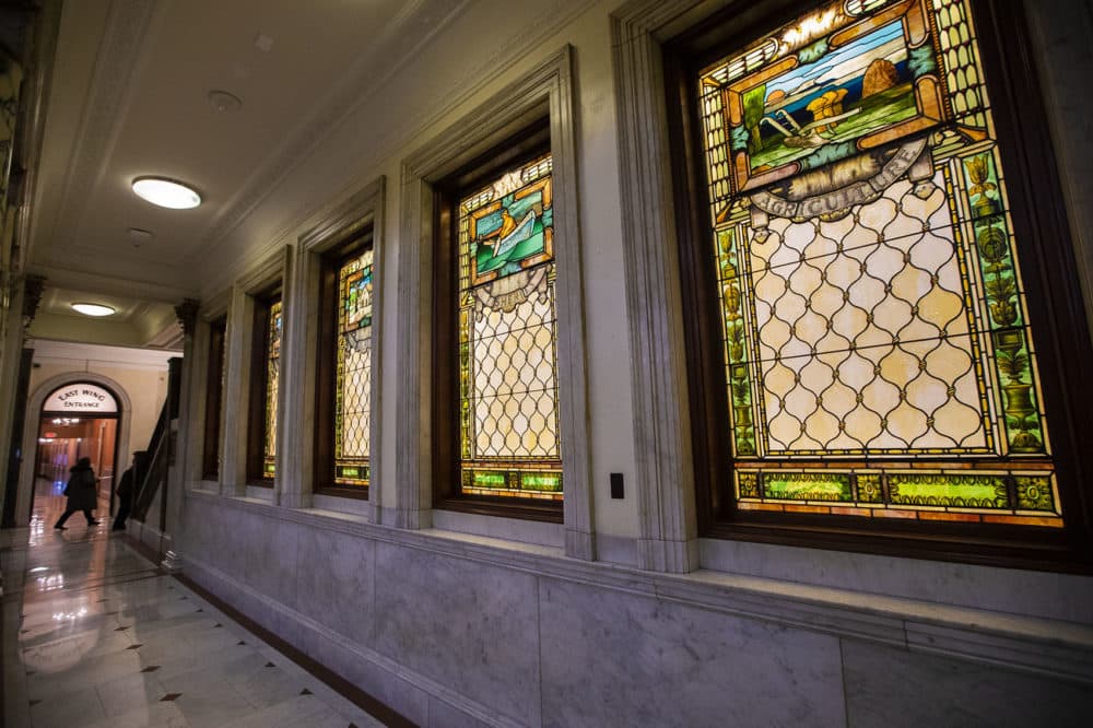 The backlit stained glass “Windows Of Industry,” which sit in the third-floor hallway outside the Senate chamber, were also replaced. (Jesse Costa/WBUR)
