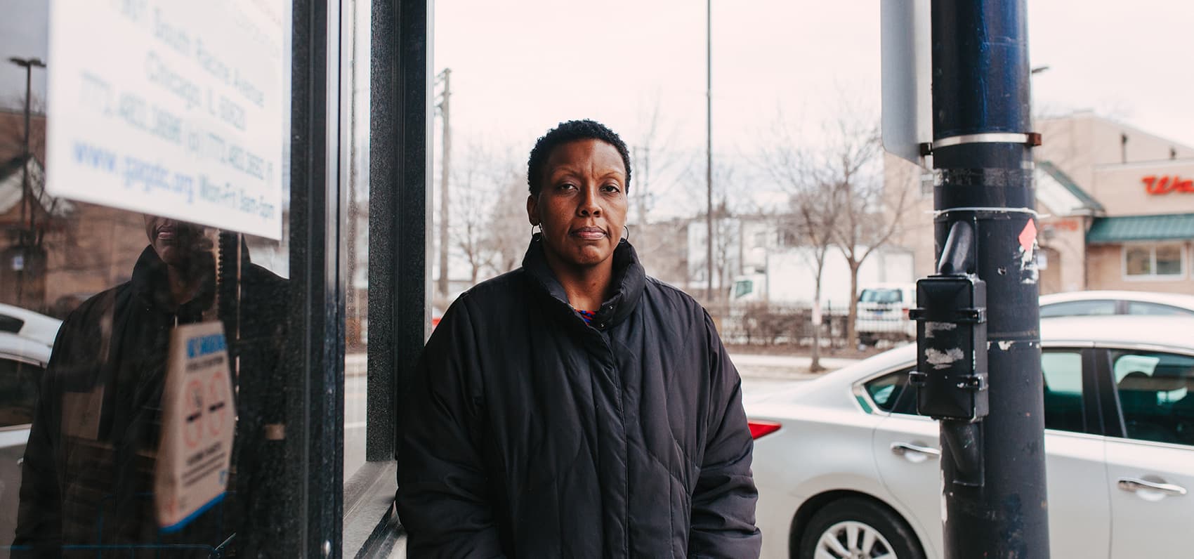Kathryn Welch, who works at the Greater Auburn-Gresham Development Corporation in Chicago, stands at the same spot where she witnessed gunfire in the lot across the street. &quot;It was a summer day and I was walking to Walgreens and I heard these pops,&quot; she says. Welch has moved from the city to South Holland, Ill., a Chicago suburb. (Danielle Scruggs for Here & Now)