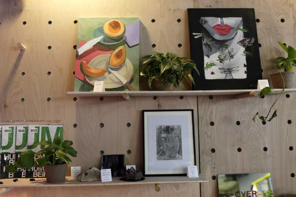 Spaceus showcases and sells art made by members in their storefront. Work shown here (left to right, descending) by Valeria Martin, Valerie Imparato, Zak Jensen, Liz Helfer, Elle DioGuardi and Cameron McCool. (Hadley Green for WBUR)