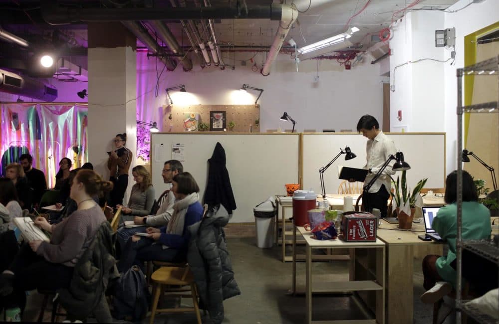 People gather for a figure drawing class at Spaceus in East Cambridge on a Wednesday evening. (Hadley Green for WBUR)