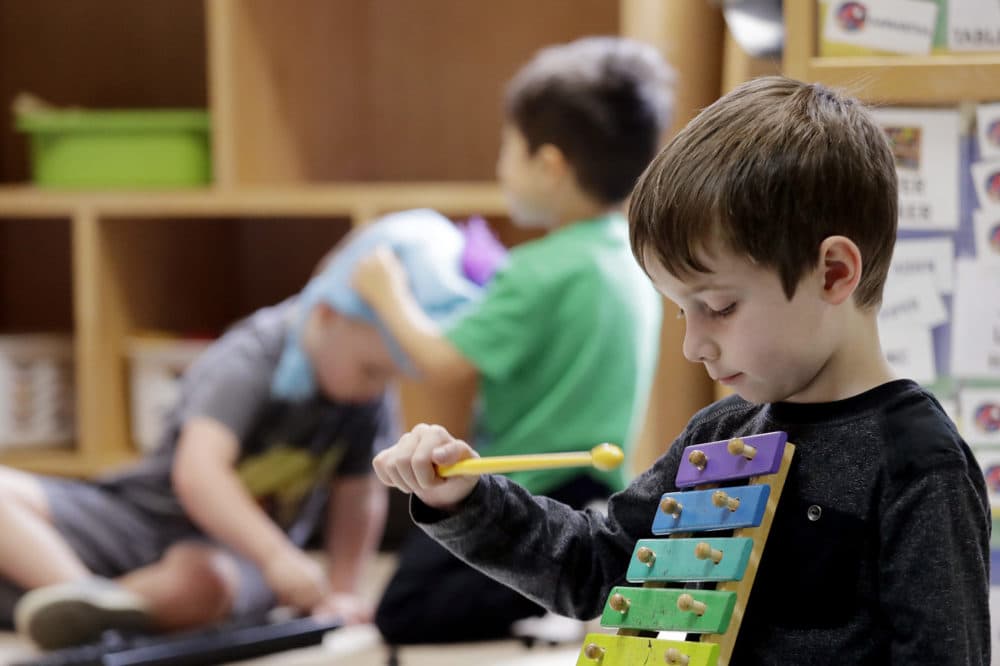 Elliott O'Neil plays on a xylophone at the Wallingford Child Care Center in Seattle. (Elaine Thompson/AP)