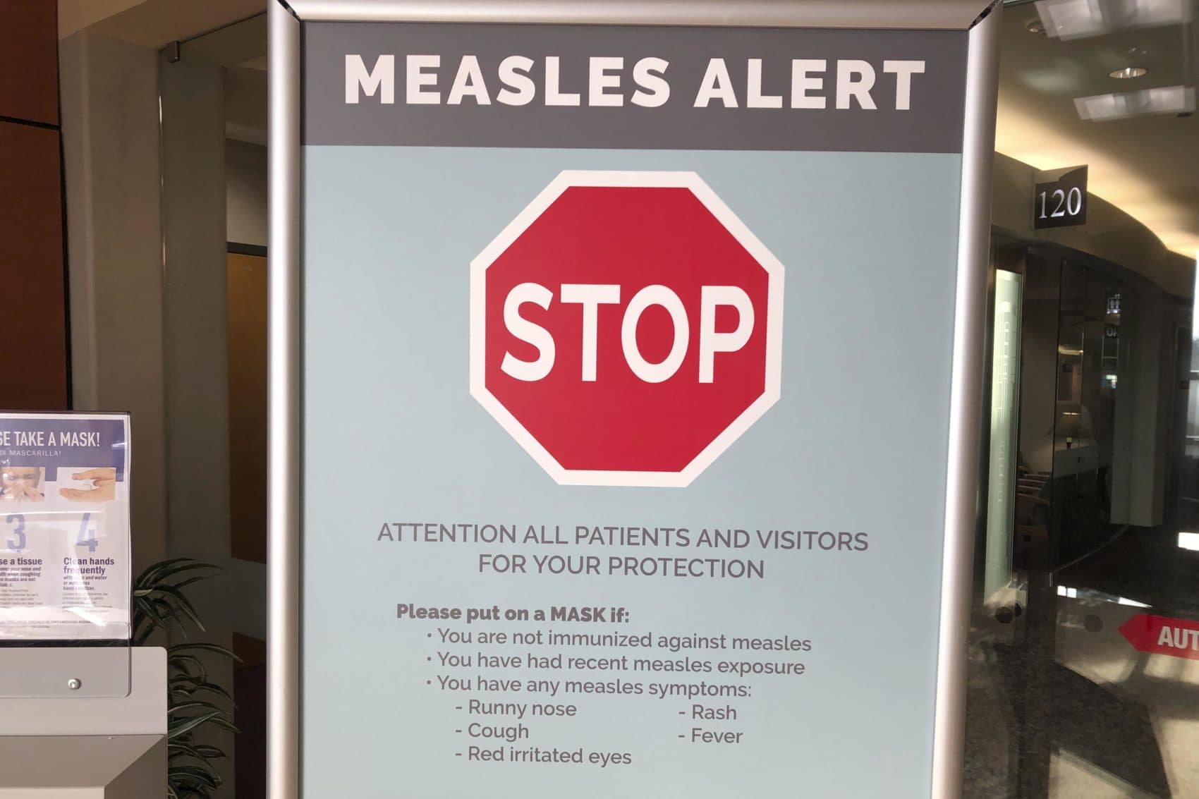 Signs posted at The Vancouver Clinic in Vancouver, Wash., warn patients and visitors of a measles outbreak on Wednesday, Jan. 30, 2019. The outbreak has sickened 39 people in the Pacific Northwest, with 13 more cases suspected. At least one patient who was sick with the measles has come to this clinic for treatment since the outbreak began Jan. 1, 2019. (AP Photo/Gillian Flaccus)