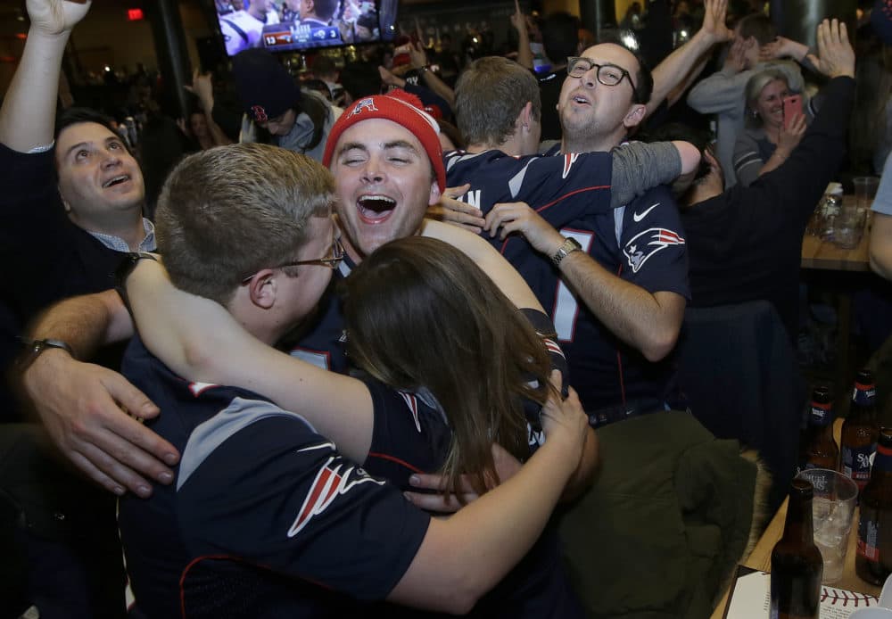 Some fans couldn't help but embrace each other after the record-breaking victory. (Steven Senne/AP)