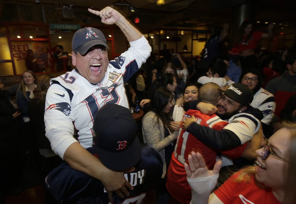 New England Patriots fan Victor Polanco, top, celebrates with others after the Patriots win. (Steven Senne/AP)