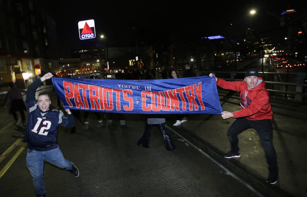 New England Patriots fans took to the streets with a banner proclaiming their territory. (Steven Senne/AP)