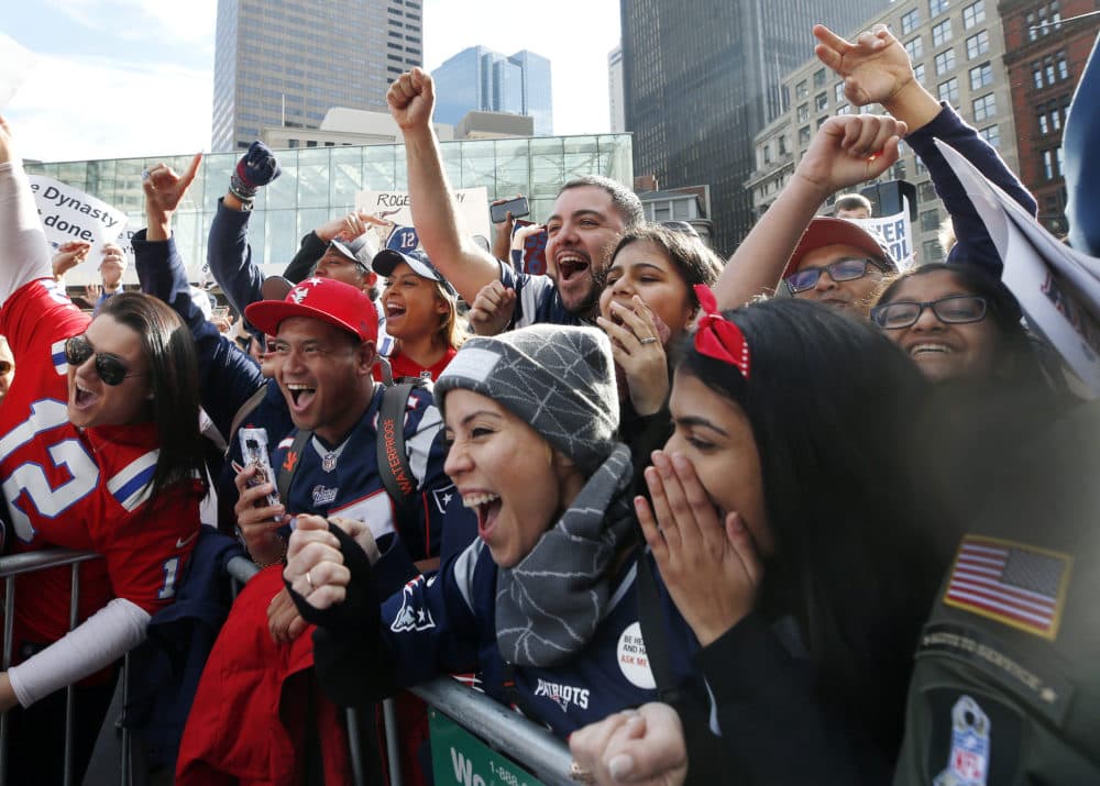 Fans cheer during the victory parade. (Elise Amendola/AP)