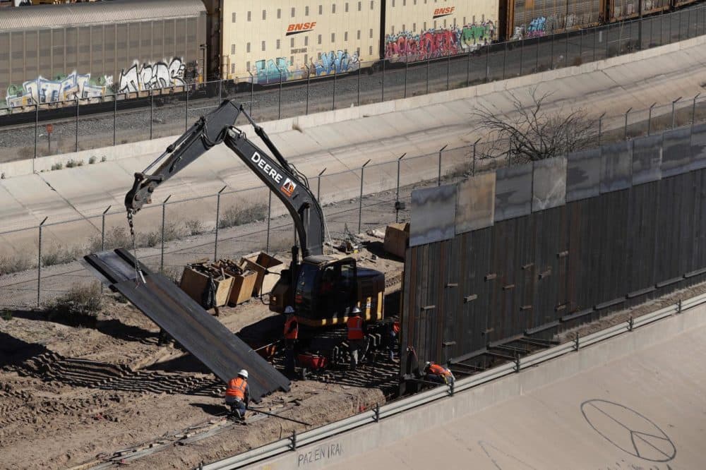 In this Tuesday, Jan. 22, 2019, photo, workers place sections of metal wall as a new barrier is built along the Texas-Mexico border near downtown El Paso. Such barriers have been a part of El Paso for decades and are currently being expanded, even as the fight over President Donald Trump's desire to wall off the entire U.S.-Mexico border. (Eric Gay/AP)