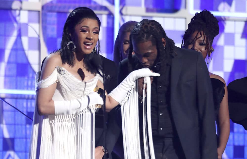 Cardi B accepts the award for best rap album for &quot;Invasion of Privacy&quot; as Offset kisses her hand. (Matt Sayles/Invision/AP)