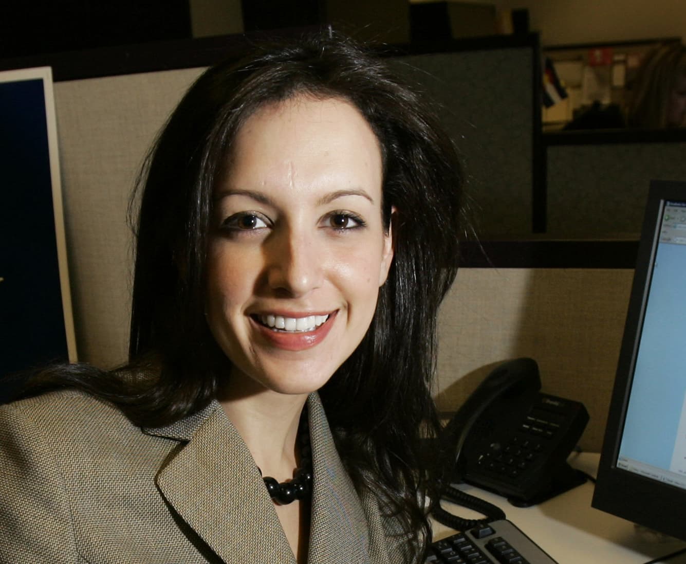In this March 23, 2007 photo, Sarah Isgur, poses at her desk at the Romney for President headquarters in Boston. (Elise Amendola/AP)