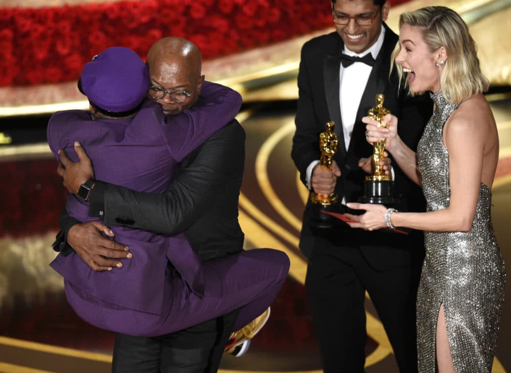 Spike Lee jumps into Samuel L. Jackson's arms after he wins an Oscar for best adapted screenplay for &quot;BlacKkKlansman.&quot; (Chris Pizzello/Invision/AP)