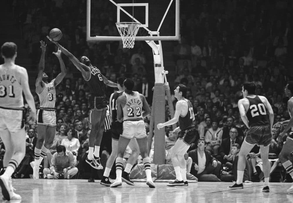 The Boston Celtics' Bill Russell (6) snags the ball away from the Lakers' Tom Hawkins, left, during the game in Los Angeles April 27, 1968. (AP)