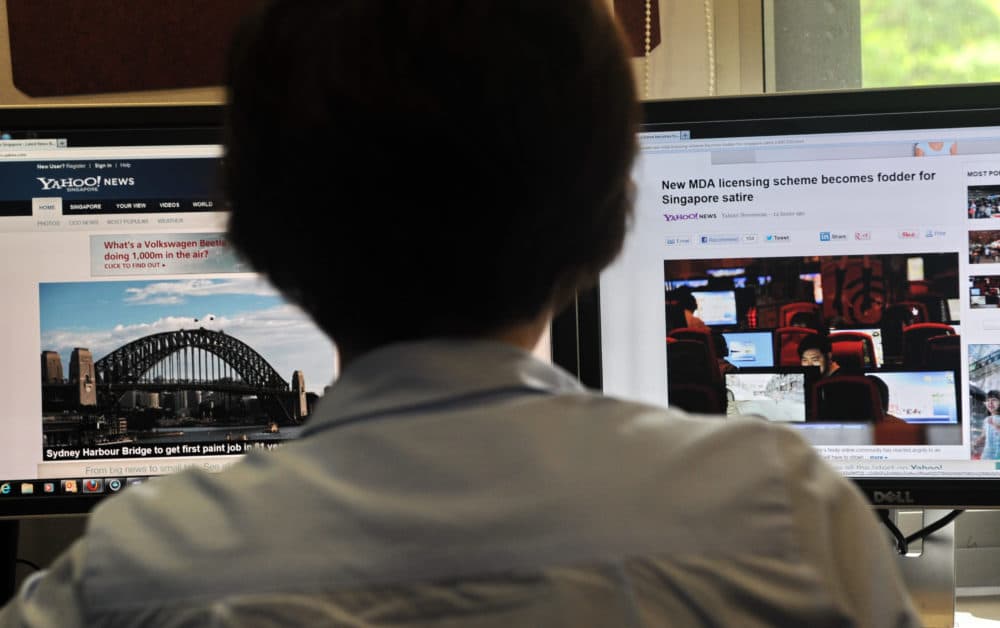 A person browses through media websites on a computer in Singapore on May 30, 2013. (Roslan Rahman/AFP/Getty Images)