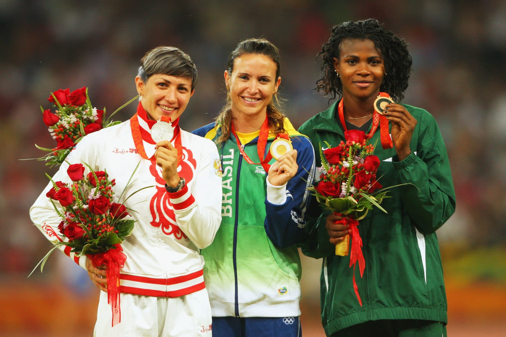 Blessing Okagbare (right) receives her medal at the 2008 Olympic Games. Tatyana Lebedeva (left) was later disqualified for doping and stripped of her silver medal. (Stu Forster/Getty Images)