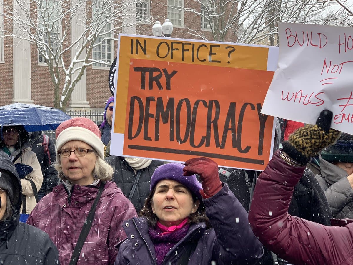 More than 100 people protested at a "Presidents Day Protest to Fight Trump's fake Crisis and Racist Deportation Forces," on Monday, Feb. 18, 2019. (Simón Rios/WBUR)