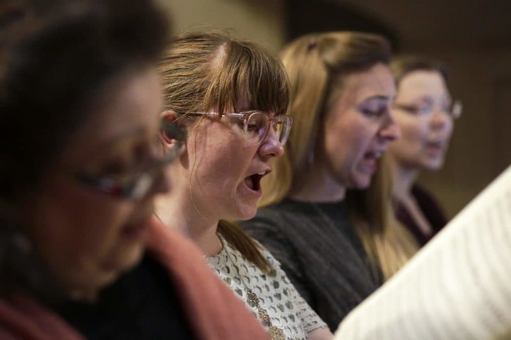 Singers in the Cappella Clausura chorus, from left, Adrianna Repetto, Janet Stone, Barbara Hill and Teri Kowiak rehearse Fanny Mendelssohn Hensel's three cantatas at the Eliot Church in Newton. (Hadley Green for WBUR)