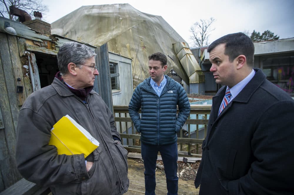 Mark Bogosian (center) and his attorneys at the geodesic dome in Woods Hole, which he plans to restore. (Jesse Costa/WBUR)
