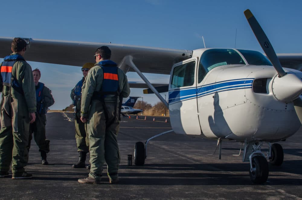 The aerial surveillance team reviews the ditch training procedure before going up in the plane (Sharon Brody/WBUR)