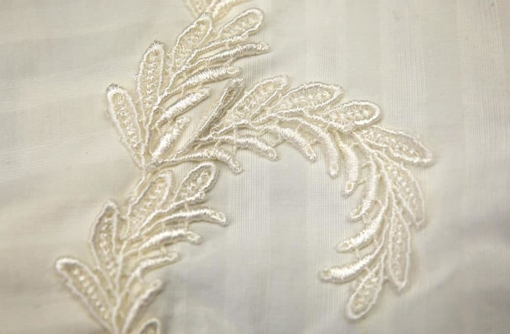 A flower appliqué hides a seam on a white &quot;shirtwaist&quot; or blouse. (Robin Lubbock/WBUR)