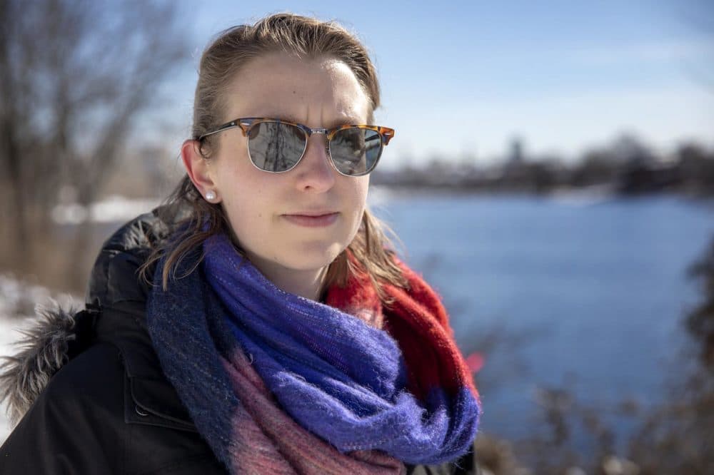 Gabby Queenan, policy director of the Massachusetts Rivers Alliance, stands by the Charles River. (Robin Lubbock/WBUR)