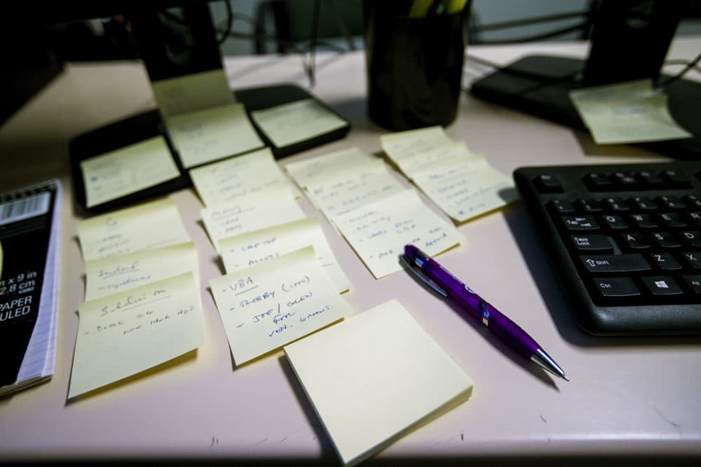 Sticky notes organized on Riga's desk. (Jesse Costa/WBUR)