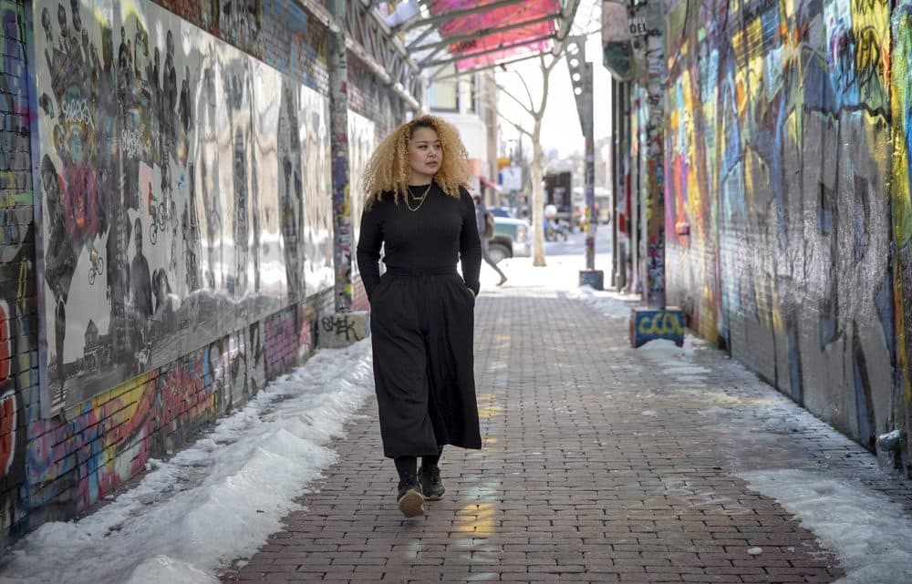 Sneha Shrestha, walks through the graffiti alley in Central Square, Cambridge. (Robin Lubbock/WBUR)