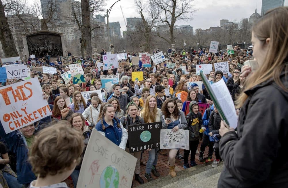 Students and supporters of the Massachusetts Youth Climate Strike, crowd around the steps of the State House in Boston. (Robin Lubbock/WBUR)